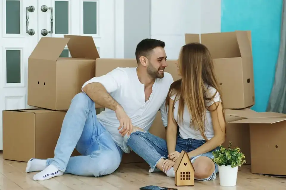 A couple sitting among moving boxes