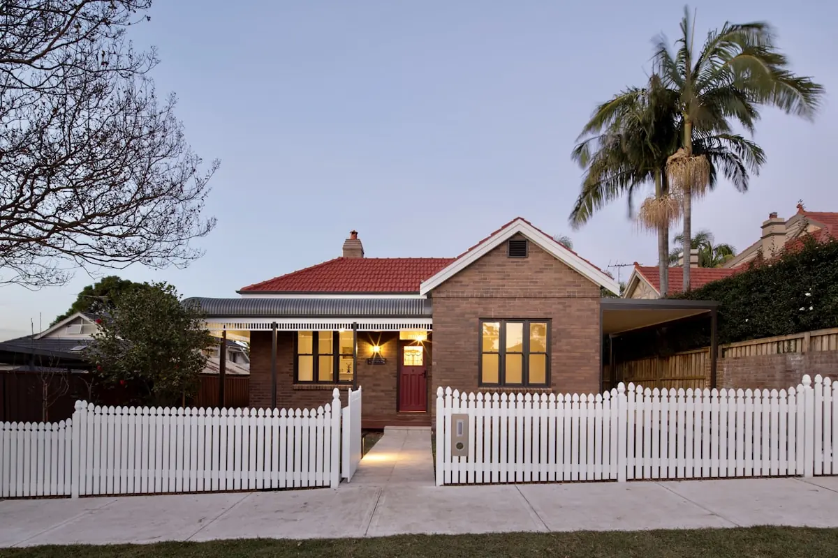A brick bungalow with a front garden