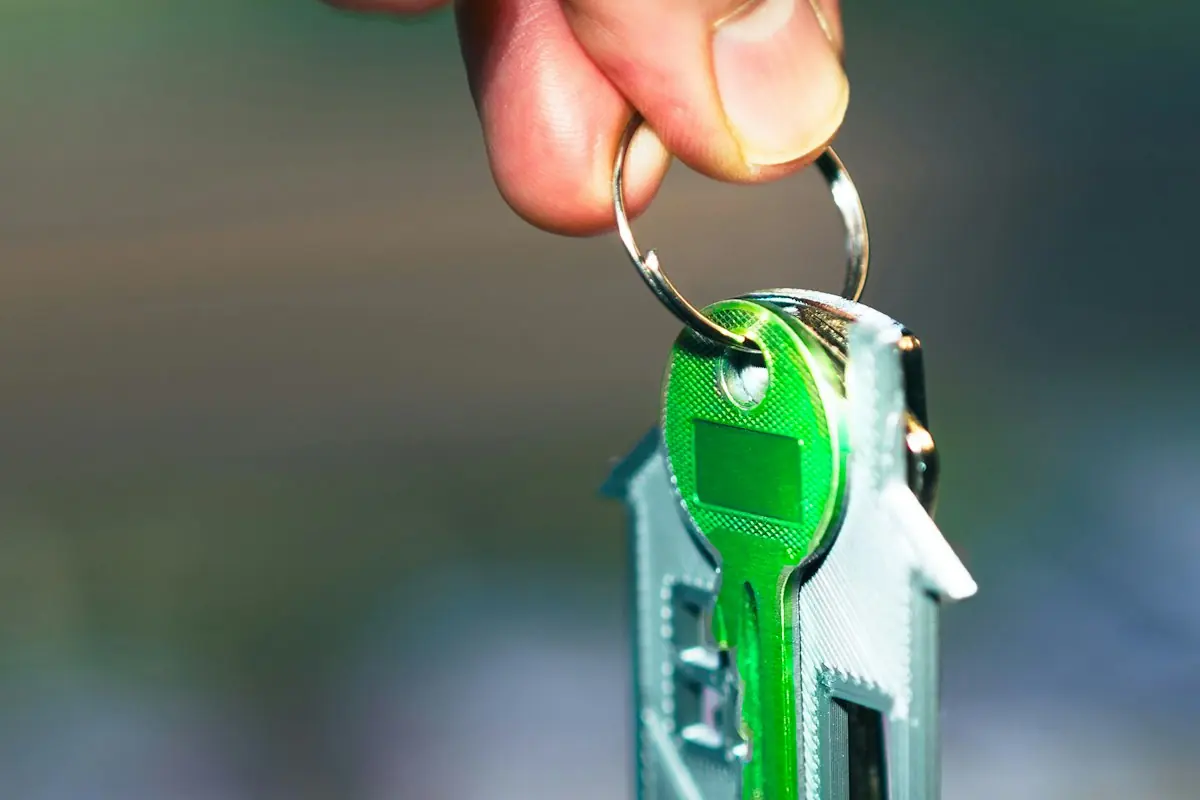 A house key on a green key ring