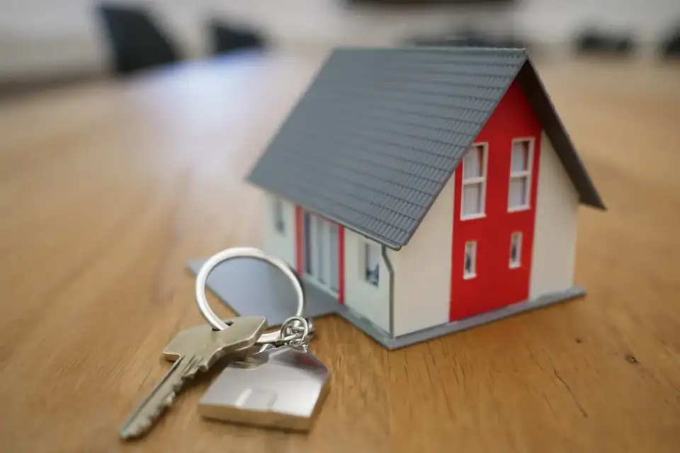 Keys beside a model house